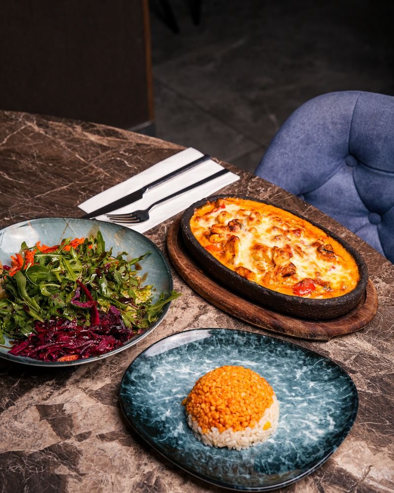A laid table at Turkoman Bar & Grill with meze, rice and salad